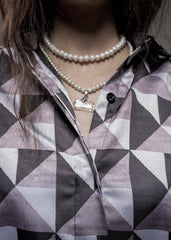 A model confidently wearing the Boss Lady Silk Co-Ord Set, showcasing the blazer and trousers combination. The outfit fits perfectly, with the model striking a powerful pose. The satin fabric glows under the light, and the ensemble is paired with minimal accessories, enhancing the modern, boss-lady vibe.