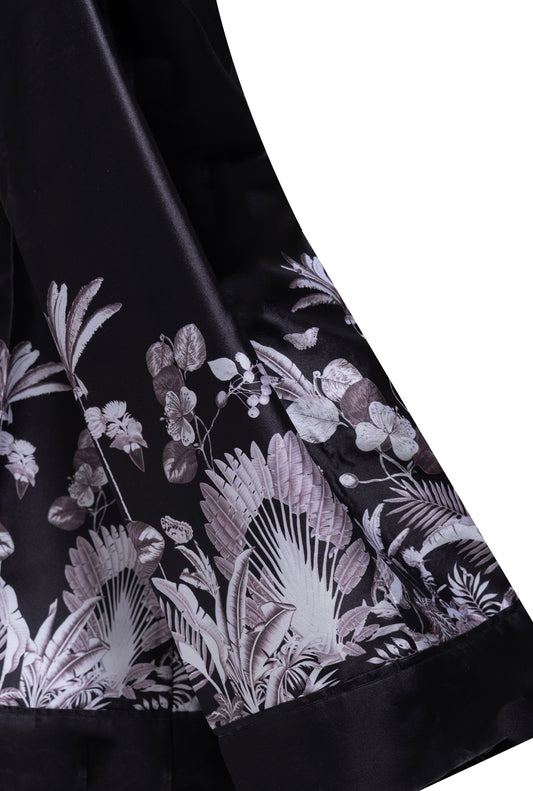 A close-up of the Boss Lady Silk Blazer, highlighting its soft, silky fabric and structured silhouette. The blazer features a single-button closure, sharp lapels, and subtle stitching details, adding a refined touch to the sophisticated design.