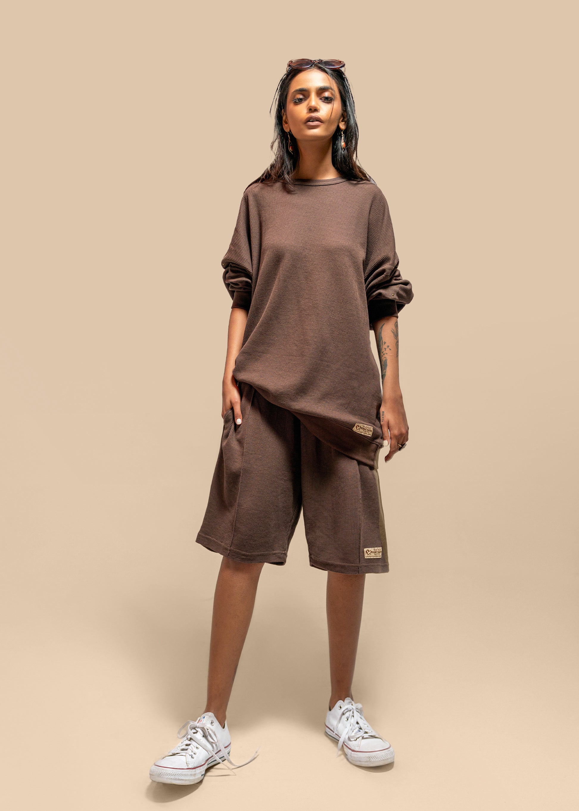 Lifestyle shot of the Toffee Brown Uni thermal short set worn by a model, showcasing its relaxed and casual vibe.