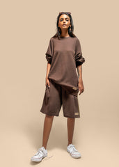 Lifestyle shot of the Toffee Brown Uni thermal short set worn by a model, showcasing its relaxed and casual vibe.