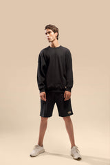  front view of the Urban Black Uni thermal short set, highlighting the cozy thermal fabric and relaxed fit.